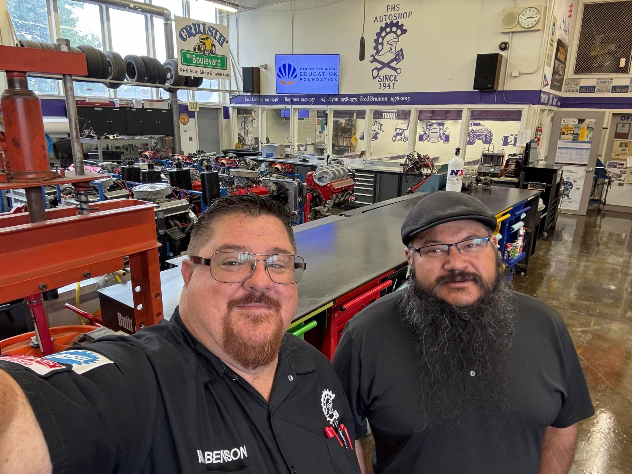 Mr. Benson and Mr. Richie inside the Petaluma High School Auto Shop engine lab